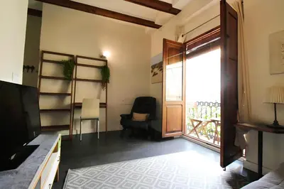 a room with a door and a chair and a window at Apartamento reformado cerca de la Plaza Redonda in Valencia