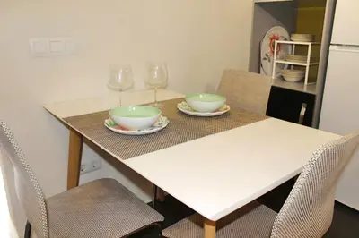 a table with two bowls and wine glasses on it at Apartamento reformado cerca de la Plaza Redonda in Valencia