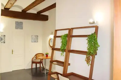 a room with a ladder and a table and a chair at Apartamento reformado cerca de la Plaza Redonda in Valencia