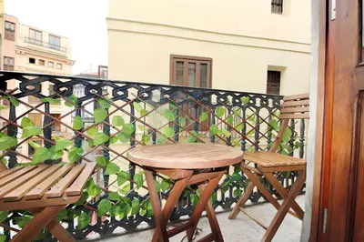 two chairs and a table on a balcony at Apartamento reformado cerca de la Plaza Redonda in Valencia