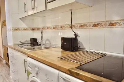 a kitchen with a counter with a toaster and a sink at Estudio con encanto en el casco antiguo de Valencia in Valencia