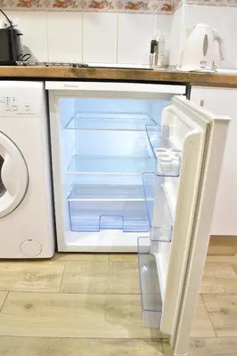 an empty refrigerator with its door open in a kitchen at Estudio con encanto en el casco antiguo de Valencia in Valencia