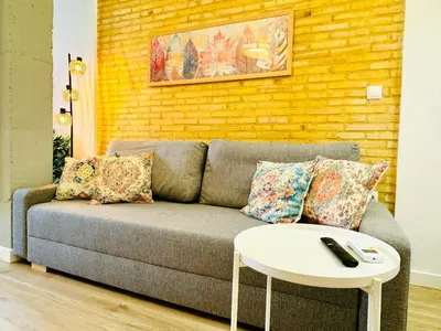 a living room with a couch and a table at Dorado Cabanyal - Luxury Beachside Charm in Valencia