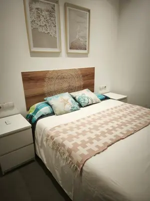 a bedroom with a large bed with two night stands at Lindo Cabanyal - Comfort Family Beachside Apartment in Valencia