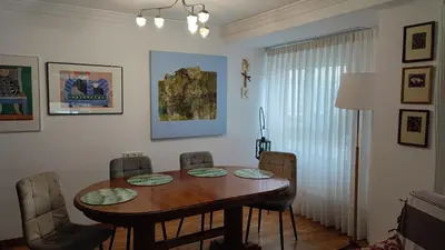 a dining room with a wooden table and chairs at Precioso apartamento a 7 minutos en tren al centro de Valencia in Benetúser