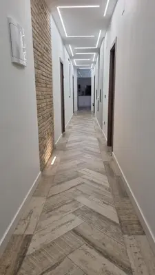 a corridor of an office building with white walls and wooden floors at Habitación céntrica de Lujo Gv 6 in Valencia