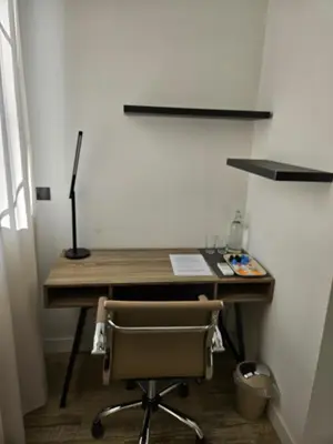 an office with a desk with a chair and a lamp at Habitación céntrica de Lujo Gv 6 in Valencia