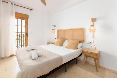 a bedroom with a large bed with towels on it at Travel Habitat Port Saplaya con vistas al Mar in Port Saplaya