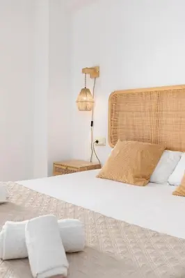 a bedroom with a large bed with two pillows at Travel Habitat Port Saplaya con vistas al Mar in Port Saplaya