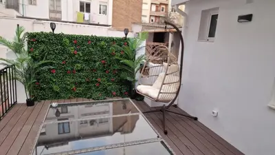 a chair sitting on a balcony with a garden at Habitación céntrica de Lujo Gv 1 in Valencia