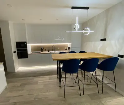 a kitchen with a wooden table and blue chairs at Habitación céntrica de Lujo Gv 3 in Valencia