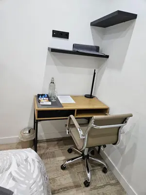 a desk with a chair next to a wall at Habitación céntrica de Lujo Gv 3 in Valencia