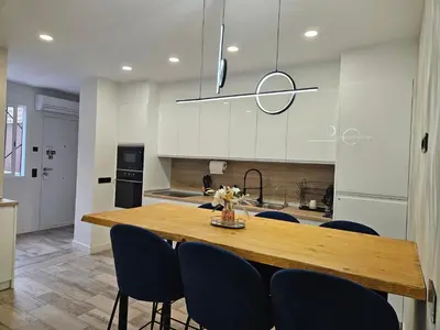a kitchen with a wooden table and blue chairs at Habitación céntrica de Lujo Gv 2 in Valencia