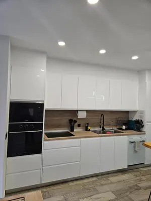 a kitchen with white cabinets and a black appliance at Habitación céntrica de Lujo Gv 2 in Valencia