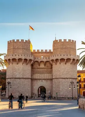 a group of people riding bikes in front of a castle at Loft independiente de Lujo. in Valencia