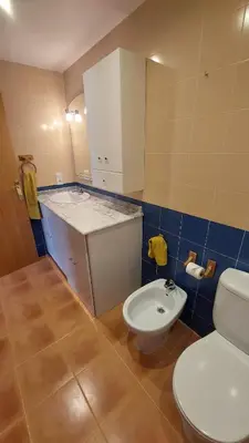 a bathroom with a toilet and a sink at Ático dúplex con vistas in Canet de Berenguer