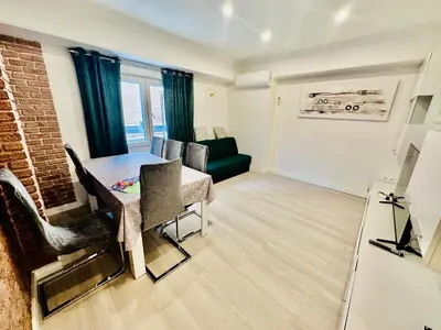 a living room with a table and a couch at Piso Lorena Playa 1min walk in Puerto de Sagunto