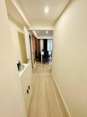 a hallway leading into a living room with wood floors at Piso Lorena Playa 1min walk in Puerto de Sagunto