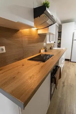 a kitchen with a wooden counter top with a sink at ¡A disfrutar de Valencia! in Valencia