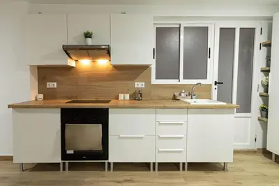 a kitchen with white cabinets and a sink at ¡A disfrutar de Valencia! in Valencia