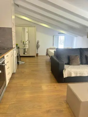 a large living room with a couch and a kitchen at Valencia Bella Flats in Valencia