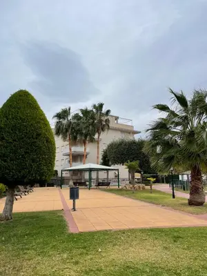 a park with a pavilion and palm trees and a building at APARTAMENTO PLANTA BAJA CANET DE BERENGUER in Canet de Berenguer