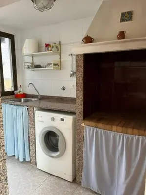 a kitchen with a washing machine and a sink at Casa mediterránea junto al mar. in Chilches