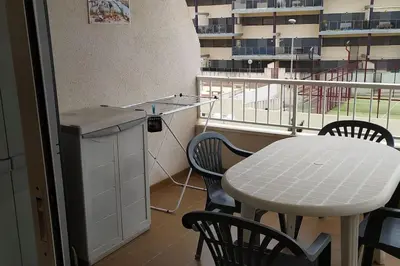 a kitchen with a table and a table and chairs at Acogedor apartamento en la playa de Canet in Canet de Berenguer