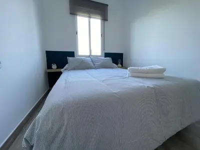 a white bed in a room with a window at Apartamento El Castell in Alaquas