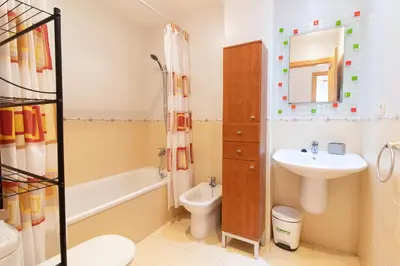 a bathroom with a sink and a toilet and a shower at Global Vacacional, Práctico apartamento con piscina en la playa de Canet in Canet de Berenguer