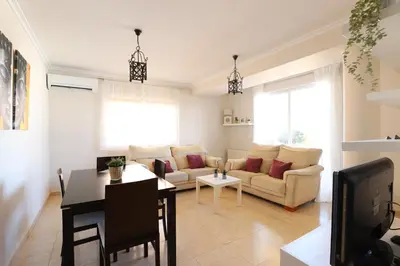 a living room with a couch and a table at Enorme terraza con vistas al mar by Hometels in Puerto de Sagunto
