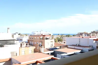 a view of the roofs of buildings in a city at Enorme terraza con vistas al mar by Hometels in Puerto de Sagunto