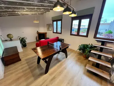 a living room with a red couch and a table at Casa Rural Judith in Segorbe
