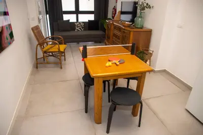 a wooden table and chairs in a living room at lifecoliving valencia loft B in Valencia
