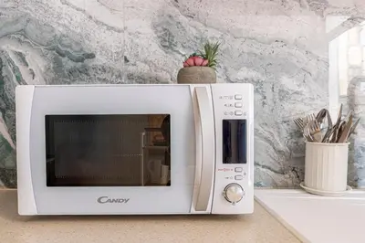 a white microwave oven sitting on a counter at Lore Loft Valencia in Valencia