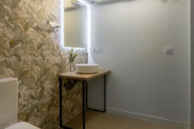 a bathroom with a sink on a wooden table at Lore Loft Valencia in Valencia