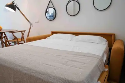 a bedroom with a bed with two mirrors on the wall at Studio chic avec terrasse, lumineux et calme 1 in Valencia