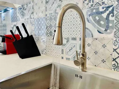 a kitchen sink with a faucet and a knife holder at Studio chic avec terrasse, lumineux et calme 1 in Valencia