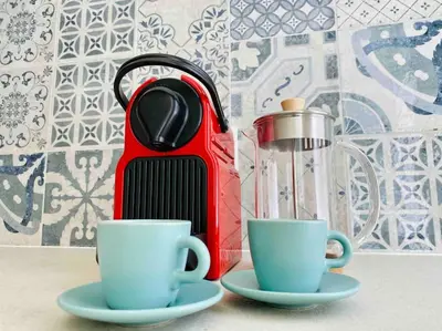 two cups of tea sitting next to a tea kettle at Studio chic avec terrasse, lumineux et calme 1 in Valencia
