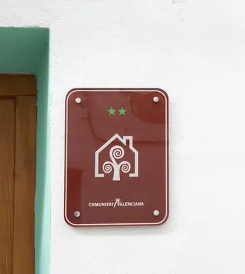a sign on the wall of a building at Casa Rural Ana Maria Ain in Ahín