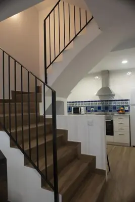a staircase leading up to a kitchen with a stair case at Casa Rural Ana Maria Ain in Ahín