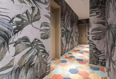 a hallway with a mural of plants on the wall at REINA FLATS VALENCIA Playa in Valencia