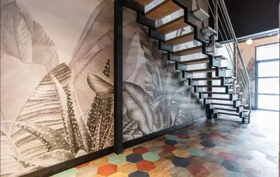 a hallway with a staircase with a mural at REINA FLATS VALENCIA Playa in Valencia