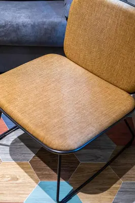 a brown chair sitting on top of a floor at REINA FLATS VALENCIA Playa in Valencia
