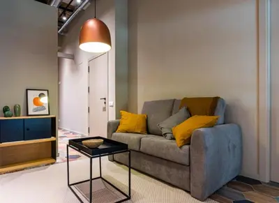 a living room with a couch and a table at REINA FLATS VALENCIA Playa in Valencia