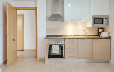 a kitchen with a stove and a microwave at Awesome Apartment In Moncofa in Moncófar
