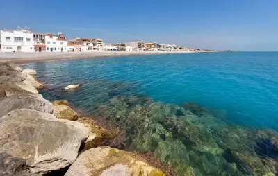 a view of a beach with rocks and the water at Awesome Apartment In Moncofa in Moncófar