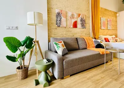 a living room with a couch and a plant at Beautiful Flat NEXT the BEACH in Valencia