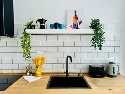 a kitchen counter with a sink and some plants at Beautiful Flat NEXT the BEACH in Valencia