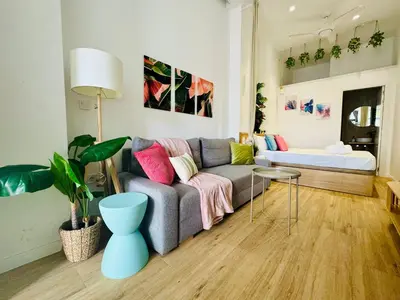 a living room with a couch and a table at Nice & Cozy Flat Close The Beach in Valencia